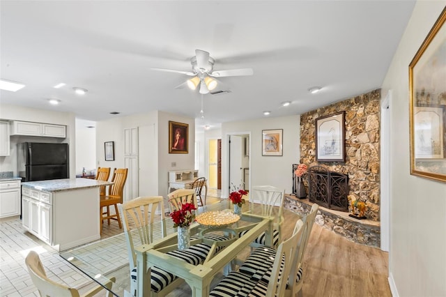 179 Frankford Ln, Palm Coast, FL 32137 - dining space with a fireplace, ceiling fan, baseboards, and recessed lighting
