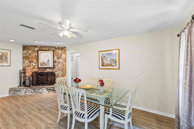 179 Frankford Ln, Palm Coast, FL 32137 - dining space with a ceiling fan, wood finished floors, baseboards, and a stone fireplace