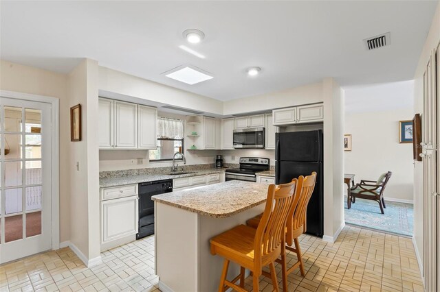 179 Frankford Ln, Palm Coast, FL 32137 - kitchen featuring black appliances, a sink, brick patterned floors, and baseboards