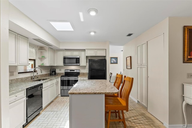 179 Frankford Ln, Palm Coast, FL 32137 - kitchen featuring black appliances, brick flooring, a breakfast bar area, open shelves, and a center island