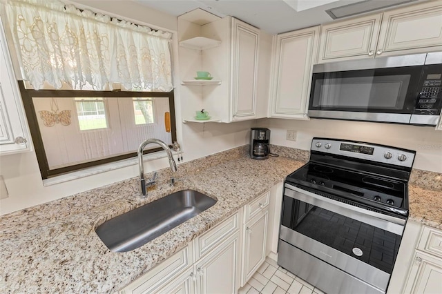 179 Frankford Ln, Palm Coast, FL 32137 - kitchen with stainless steel appliances, a sink, open shelves, and light stone countertops