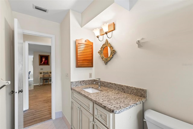 179 Frankford Ln, Palm Coast, FL 32137 - half bathroom with toilet, vanity, tile patterned flooring, and baseboards