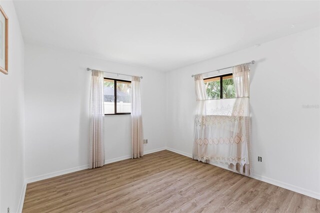 179 Frankford Ln, Palm Coast, FL 32137 - empty room featuring wood finished floors, healthy amount of natural light, and baseboards