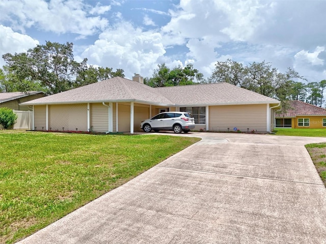 179 Frankford Ln, Palm Coast, FL 32137 - ranch-style house featuring driveway, a front yard, a garage, and a chimney