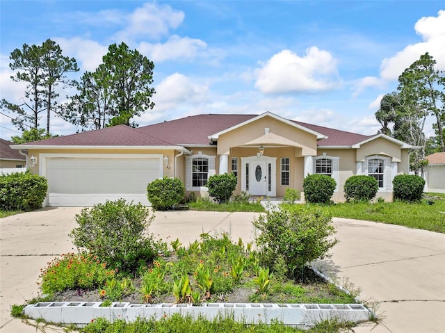 42 Raintree Pl, Palm Coast, FL 32164 - ranch-style house featuring driveway, a garage, and stucco siding