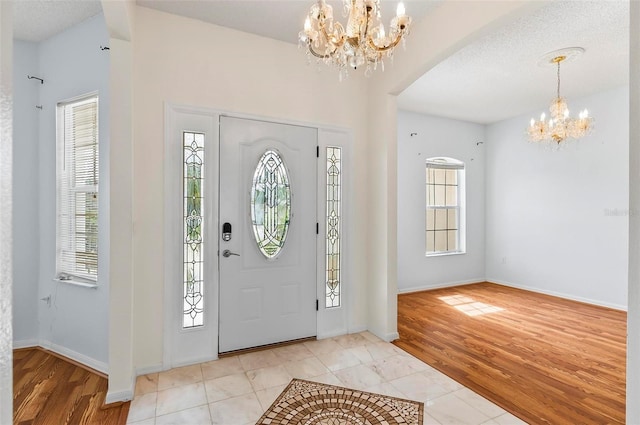 42 Raintree Pl, Palm Coast, FL 32164 - foyer with a chandelier, arched walkways, plenty of natural light, and baseboards