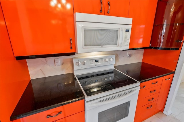 42 Raintree Pl, Palm Coast, FL 32164 - kitchen featuring white appliances, decorative backsplash, and dark countertops