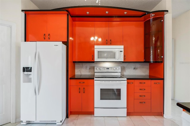 42 Raintree Pl, Palm Coast, FL 32164 - kitchen with white appliances, dark countertops, decorative backsplash, and a textured ceiling