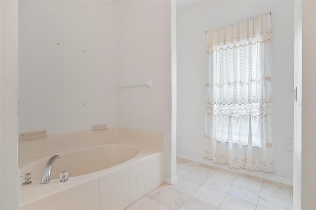 42 Raintree Pl, Palm Coast, FL 32164 - bathroom featuring a garden tub and baseboards