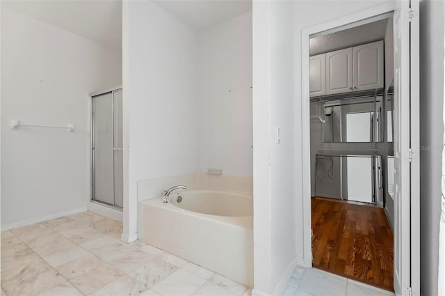 42 Raintree Pl, Palm Coast, FL 32164 - full bath with a bath, a stall shower, and baseboards