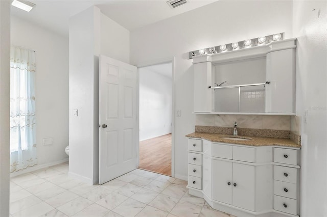 42 Raintree Pl, Palm Coast, FL 32164 - bathroom featuring vanity, toilet, a shower with shower door, and baseboards