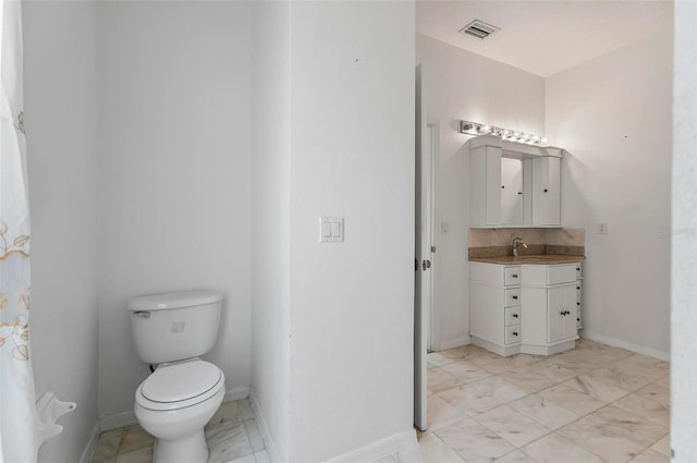 42 Raintree Pl, Palm Coast, FL 32164 - bathroom with marble finish flooring, vanity, toilet, and baseboards