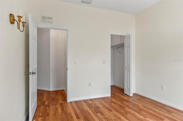42 Raintree Pl, Palm Coast, FL 32164 - unfurnished bedroom with light wood-style floors, baseboards, and a closet