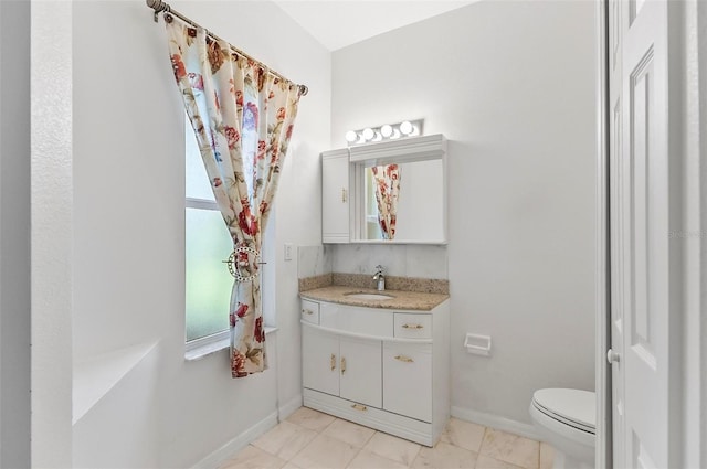 42 Raintree Pl, Palm Coast, FL 32164 - bathroom with toilet, vanity, and baseboards
