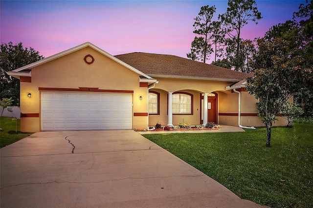 4 Seathorn Path, Palm Coast, FL 32164 - view of front of home with a front yard, driveway, stucco siding, and a garage