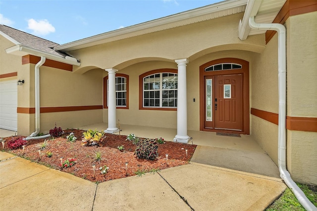 4 Seathorn Path, Palm Coast, FL 32164 - doorway to property featuring stucco siding, an attached garage, and a porch