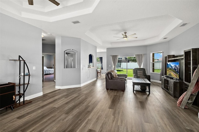 4 Seathorn Path, Palm Coast, FL 32164 - living room featuring a tray ceiling, ceiling fan, and dark wood-type flooring