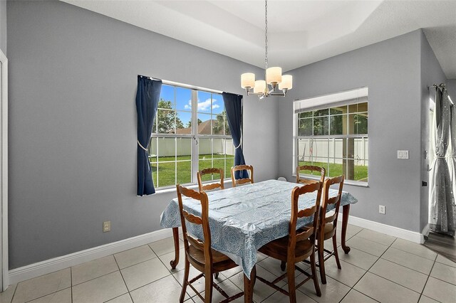 4 Seathorn Path, Palm Coast, FL 32164 - dining space featuring a chandelier, light tile patterned floors, and a tray ceiling