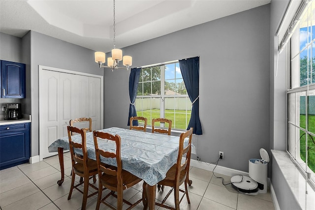 4 Seathorn Path, Palm Coast, FL 32164 - dining room featuring a chandelier, a raised ceiling, and light tile patterned floors