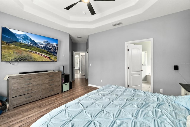 4 Seathorn Path, Palm Coast, FL 32164 - bedroom with a tray ceiling, wood finished floors, a ceiling fan, and ensuite bath