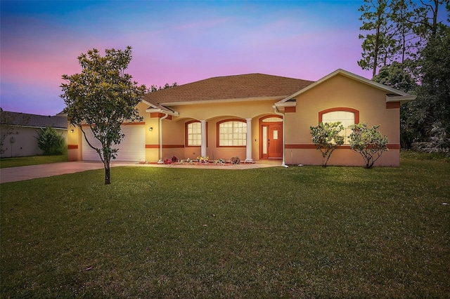 4 Seathorn Path, Palm Coast, FL 32164 - mediterranean / spanish-style house with concrete driveway, a front lawn, an attached garage, and stucco siding
