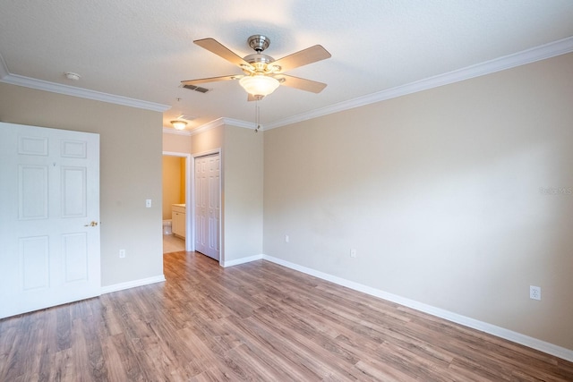 1400 Canopy Walk Ln Unit 1413, Palm Coast, FL 32137 - unfurnished bedroom featuring wood finished floors, crown molding, a closet, and a ceiling fan
