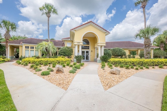 1400 Canopy Walk Ln Unit 1413, Palm Coast, FL 32137 - view of front of house with french doors, a tiled roof, and stucco siding