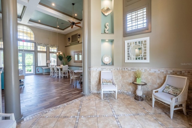 1400 Canopy Walk Ln Unit 1413, Palm Coast, FL 32137 - sitting room with a towering ceiling, decorative columns, tile walls, wainscoting, and coffered ceiling