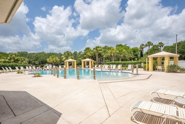 1400 Canopy Walk Ln Unit 1413, Palm Coast, FL 32137 - community pool featuring a gazebo, view of wooded area, and a patio area