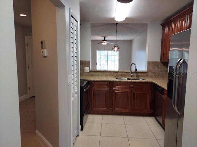 95 Rivers Edge Ln Unit 95, Palm Coast, FL 32137 - kitchen featuring a sink, stainless steel appliances, light tile patterned floors, decorative backsplash, and light stone counters