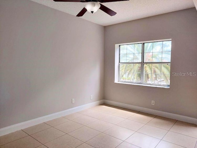 95 Rivers Edge Ln Unit 95, Palm Coast, FL 32137 - empty room featuring ceiling fan, light tile patterned flooring, baseboards, and a textured ceiling