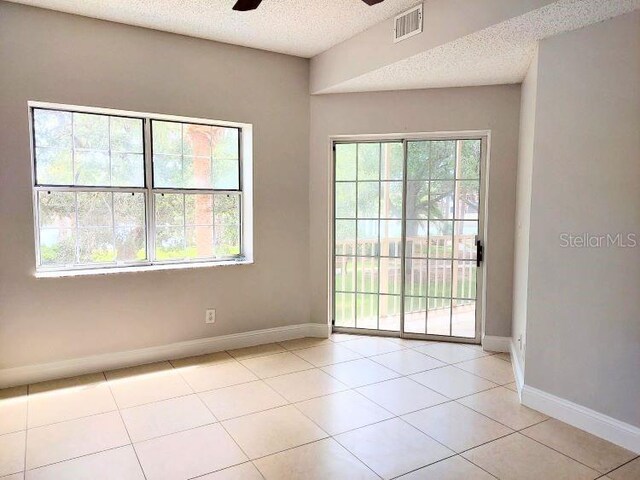 95 Rivers Edge Ln Unit 95, Palm Coast, FL 32137 - spare room with ceiling fan, baseboards, a textured ceiling, and light tile patterned floors