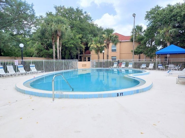 95 Rivers Edge Ln Unit 95, Palm Coast, FL 32137 - community pool featuring a patio area