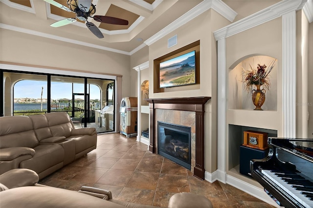 207 S Riverwalk Dr, Palm Coast, FL 32137 - living area featuring a ceiling fan, ornamental molding, a tiled fireplace, a water view, and a towering ceiling