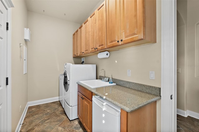 207 S Riverwalk Dr, Palm Coast, FL 32137 - laundry room featuring cabinet space and dark stone finish floors