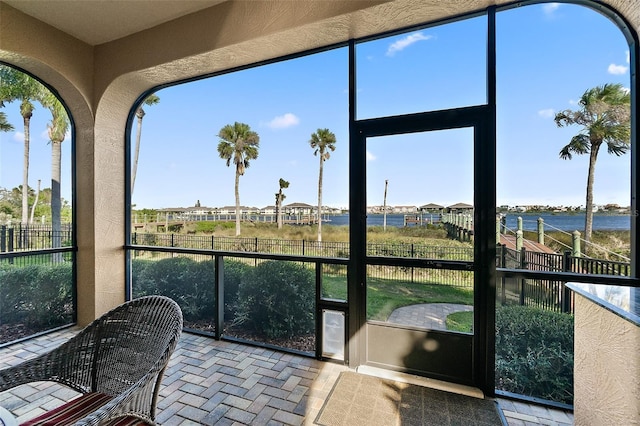 207 S Riverwalk Dr, Palm Coast, FL 32137 - sunroom featuring brick flooring and healthy amount of natural light