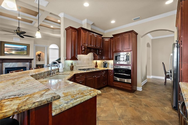 207 S Riverwalk Dr, Palm Coast, FL 32137 - kitchen with appliances with stainless steel finishes, arched walkways, ceiling fan, a peninsula, and decorative backsplash