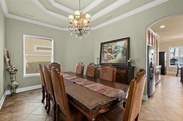 207 S Riverwalk Dr, Palm Coast, FL 32137 - dining space with arched walkways, light tile patterned floors, crown molding, a chandelier, and a raised ceiling