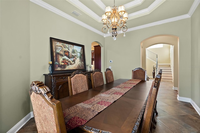 207 S Riverwalk Dr, Palm Coast, FL 32137 - dining area featuring arched walkways, a chandelier, ornamental molding, stairway, and a tray ceiling