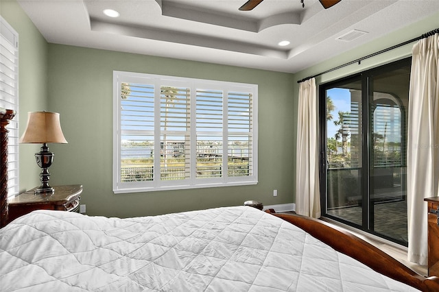 207 S Riverwalk Dr, Palm Coast, FL 32137 - bedroom featuring access to exterior, multiple windows, a tray ceiling, and recessed lighting