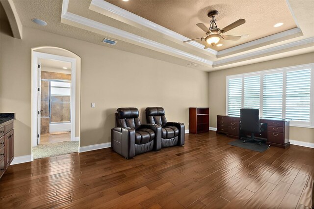 207 S Riverwalk Dr, Palm Coast, FL 32137 - office with a raised ceiling, dark wood finished floors, ceiling fan, crown molding, and arched walkways