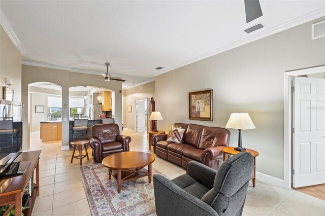 200 Riverfront Dr Unit D302, Palm Coast, FL 32137 - living room with arched walkways, light tile patterned floors, ornamental molding, a ceiling fan, and decorative columns
