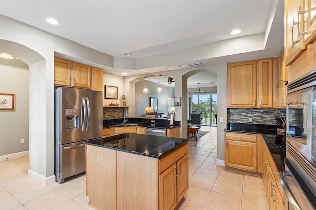 200 Riverfront Dr Unit D302, Palm Coast, FL 32137 - kitchen featuring stainless steel appliances, arched walkways, dark countertops, decorative backsplash, and light tile patterned flooring