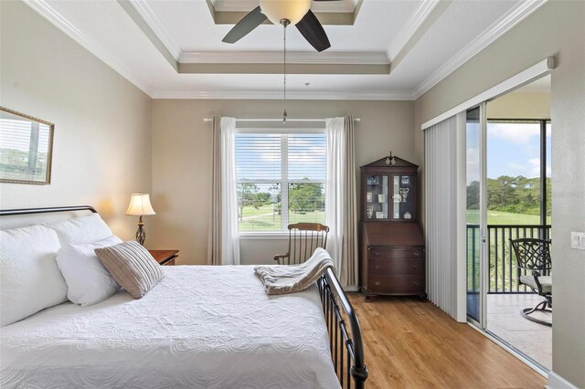 200 Riverfront Dr Unit D302, Palm Coast, FL 32137 - bedroom featuring a raised ceiling, access to outside, wood finished floors, ornamental molding, and ceiling fan