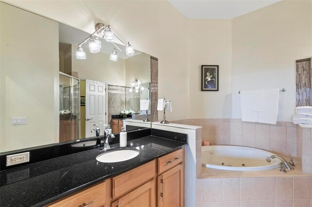 200 Riverfront Dr Unit D302, Palm Coast, FL 32137 - full bathroom featuring a whirlpool tub, vanity, and a shower stall