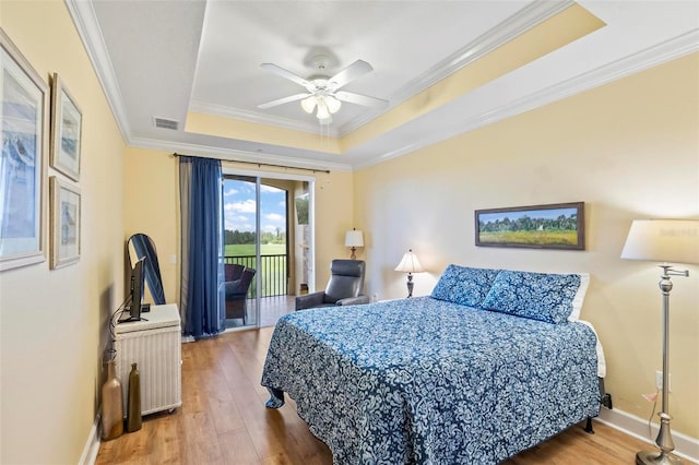 200 Riverfront Dr Unit D302, Palm Coast, FL 32137 - bedroom with a raised ceiling, access to exterior, wood finished floors, ornamental molding, and a ceiling fan