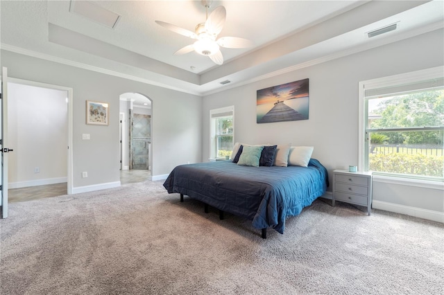 265 Pinehurst Pointe Dr, Saint Augustine, FL 32092 - bedroom with a tray ceiling, light carpet, arched walkways, ornamental molding, and ceiling fan