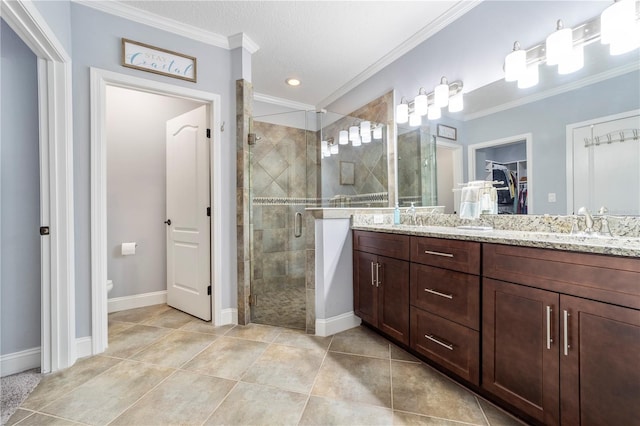 265 Pinehurst Pointe Dr, Saint Augustine, FL 32092 - bathroom featuring double vanity, a shower stall, a spacious closet, ornamental molding, and tile patterned flooring