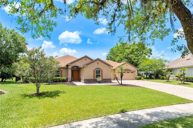 265 Pinehurst Pointe Dr, Saint Augustine, FL 32092 - mediterranean / spanish house with stucco siding, driveway, an attached garage, stone siding, and a front yard