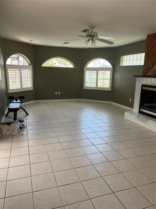 250 Beechwood Ln, Palm Coast, FL 32137 - unfurnished living room with light tile patterned flooring, ceiling fan, and a fireplace with raised hearth